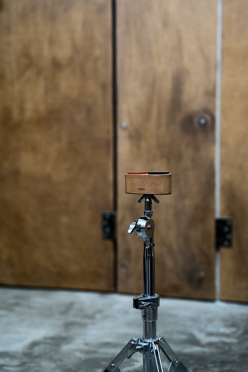 DUO mountable practice pad attached directly to a standard cymbal stand thread for ergonomic drum training.